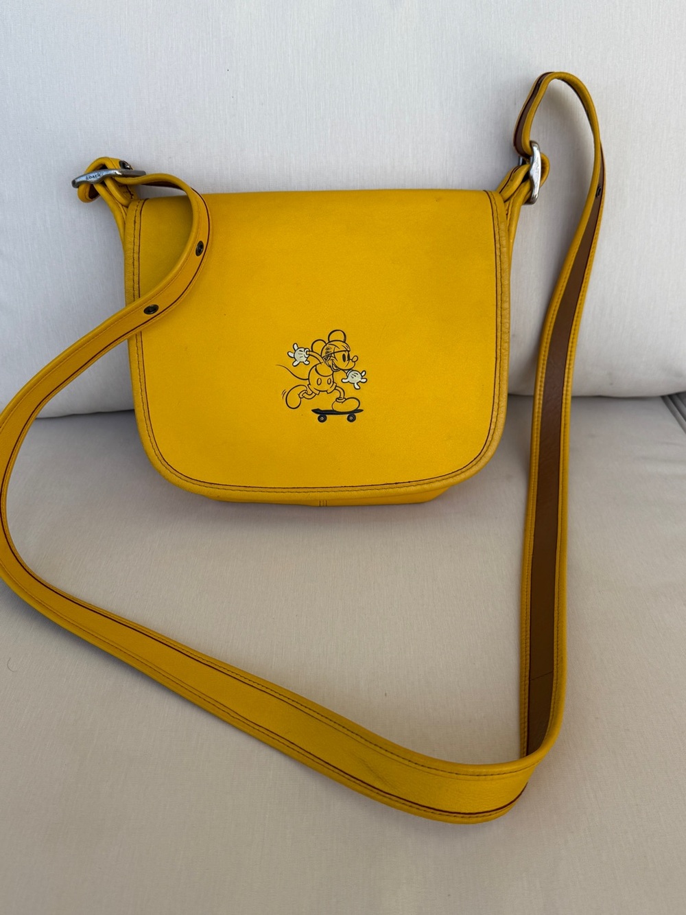 Coach x Disney yellow Mickey Mouse skateboarding leather saddle bag
